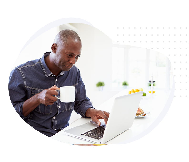 Claims_HeaderImage Gentleman reading about the claims process on laptop with coffee mug in hand