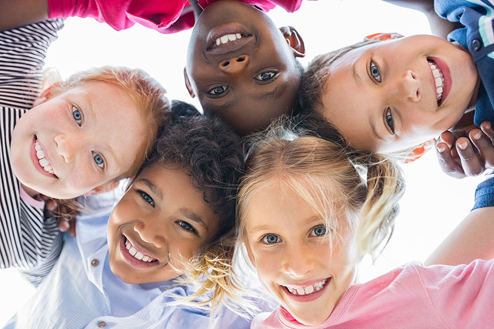 Group-of-children-smiling-together Group of children smiling together